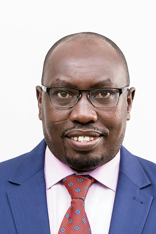 a bald headed man wearing a suit and tie