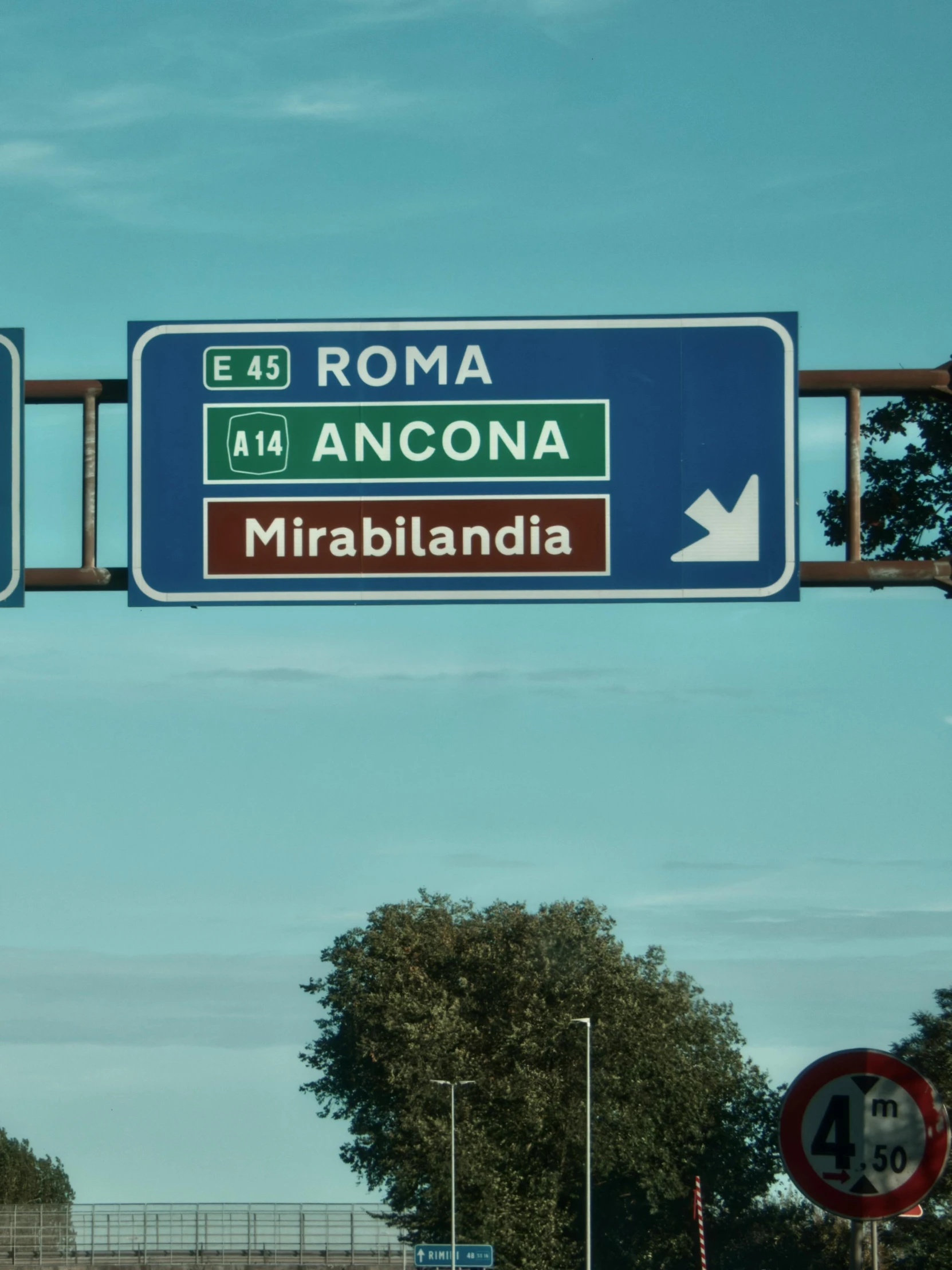 a couple of large signs above a highway