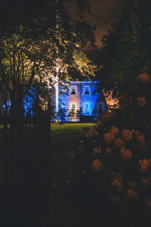 a house lit up with lights on it's side