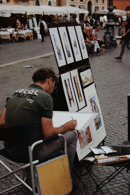 a man sits while looking at an art piece