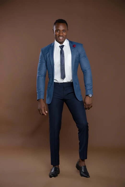 man with suit and tie posing on a brown background