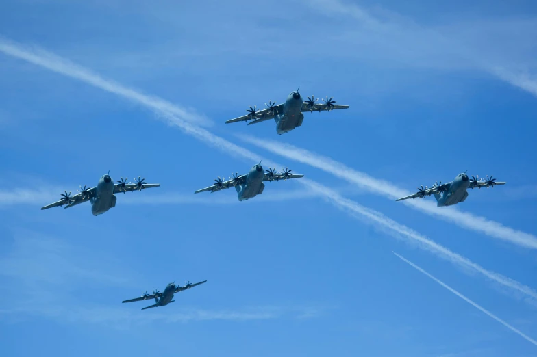 four jets flying through the sky in formation