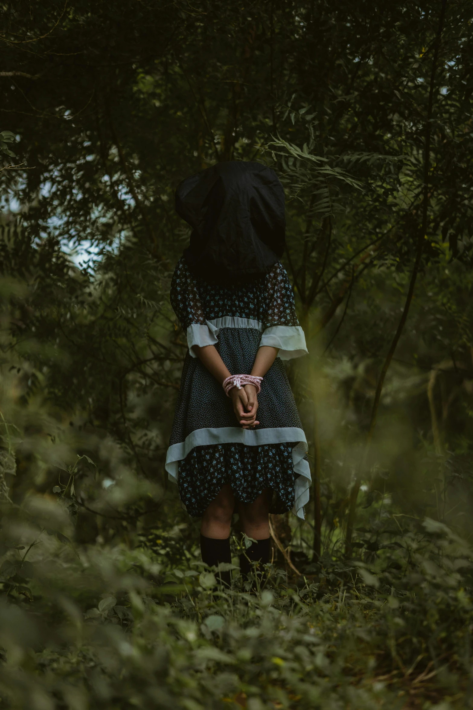 a woman is standing alone in a field