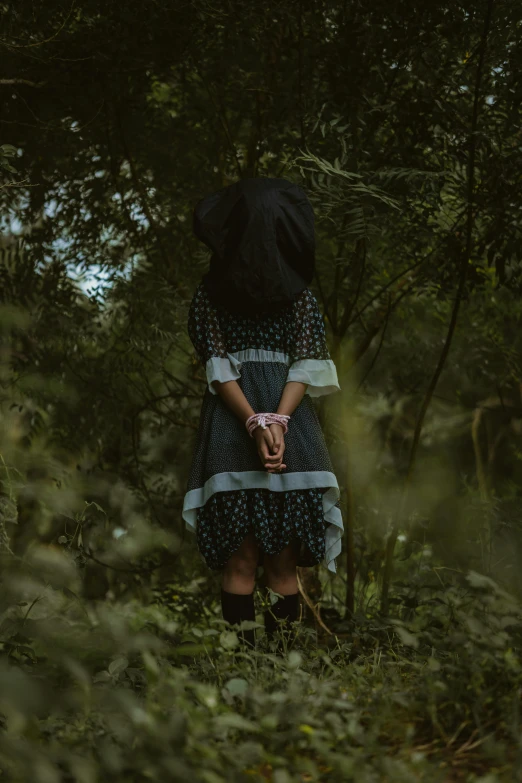 a woman is standing alone in a field