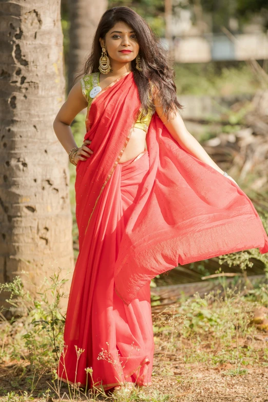 a woman in a red sari posing