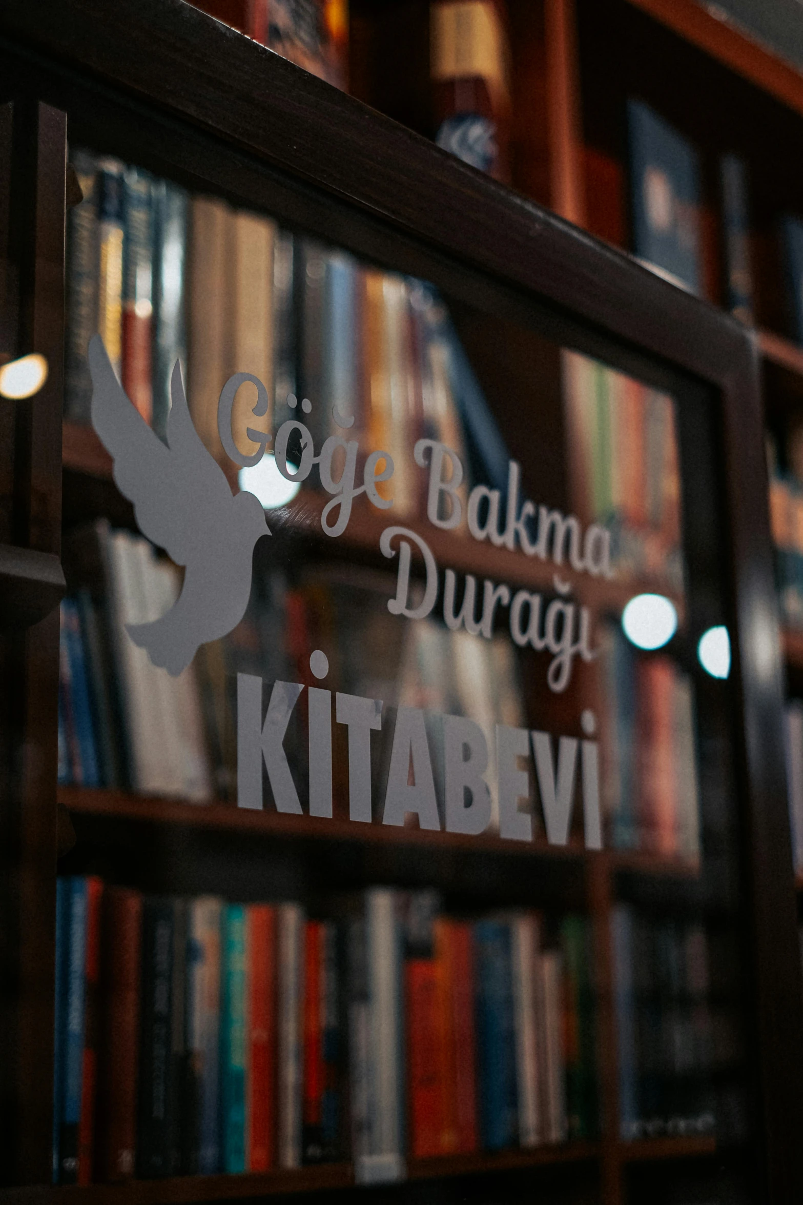 the reflection of books on display in the window