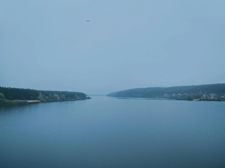 an airplane is flying over a large body of water