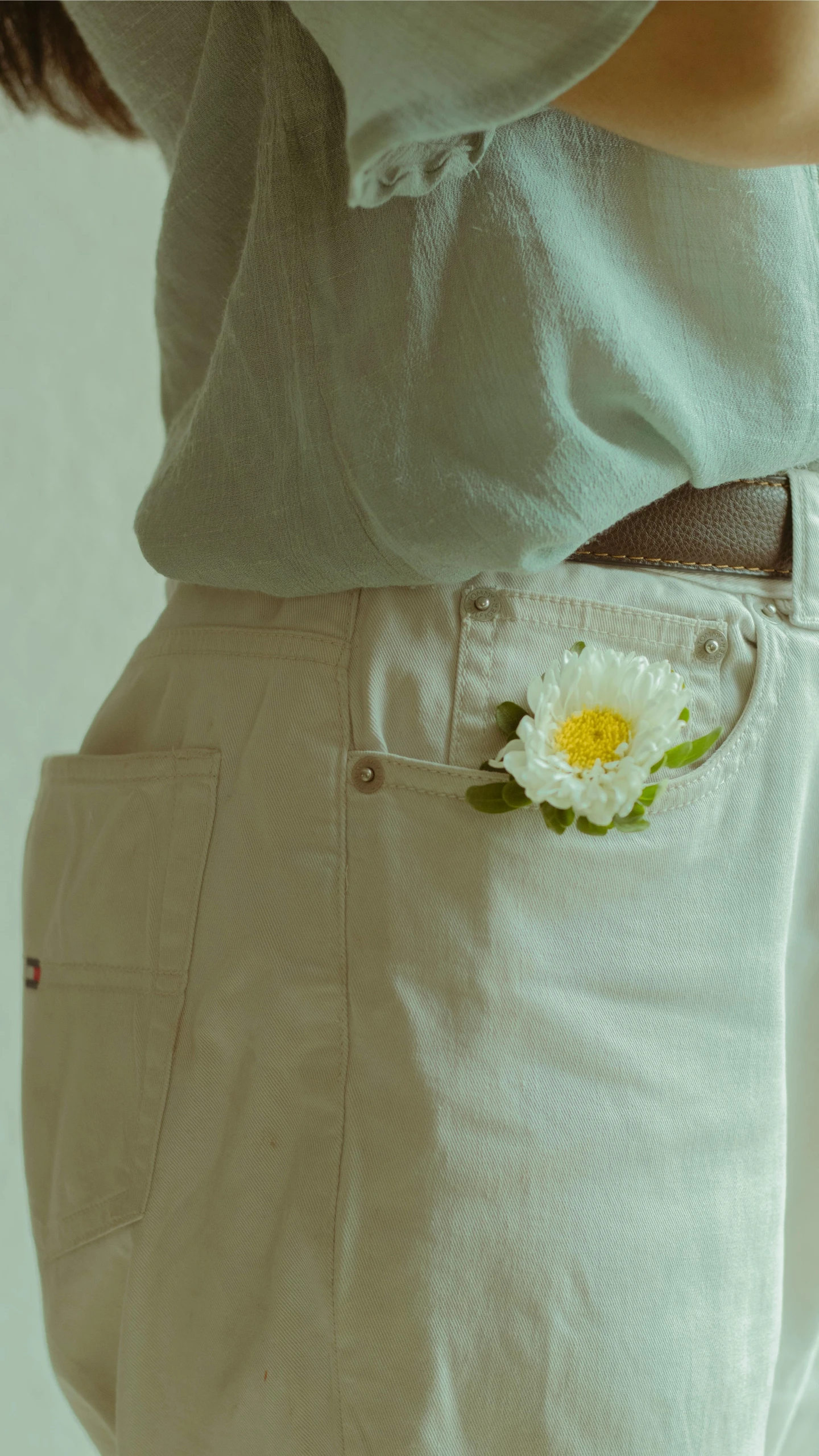 a persons belly with a flower in his pocket