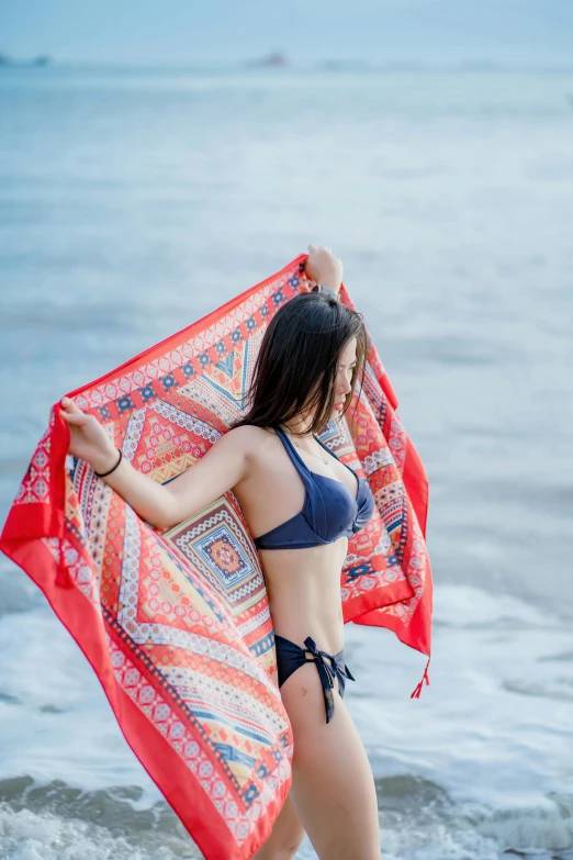 a women wearing a bikini while standing in the ocean