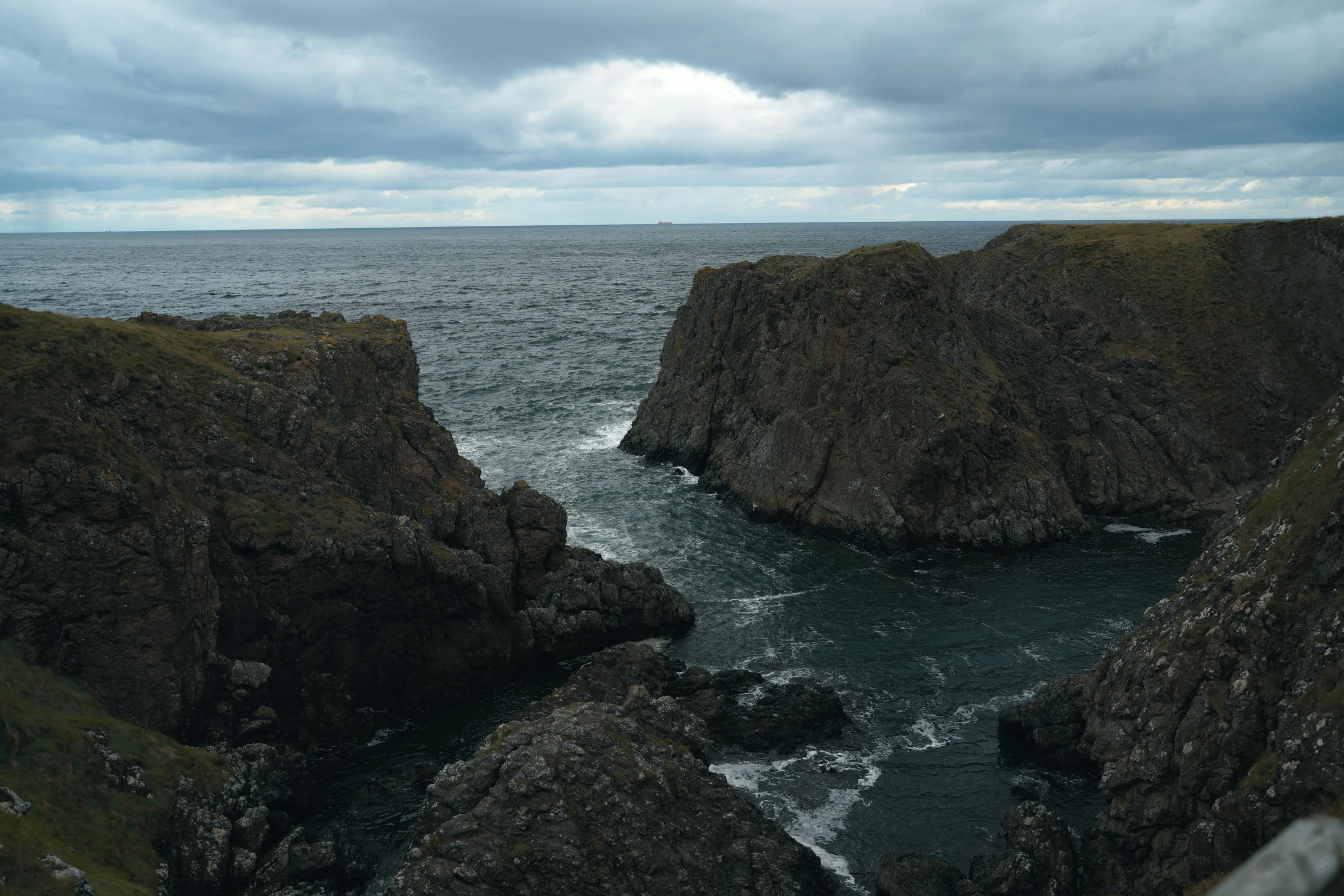 a rocky coast sitting on top of a hill by the ocean