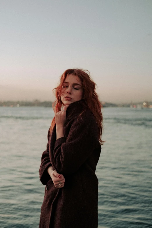 a woman looking out into the ocean