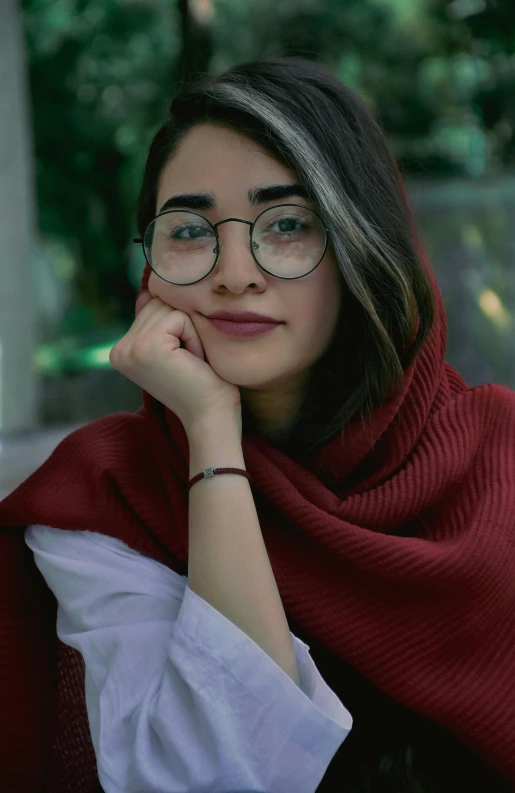 the woman has a red sweater and glasses on