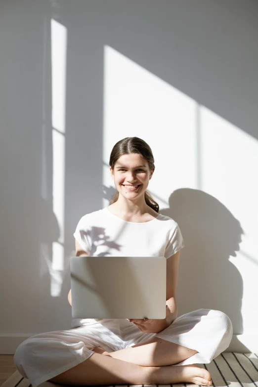 young woman sitting on floor with papers in her hands