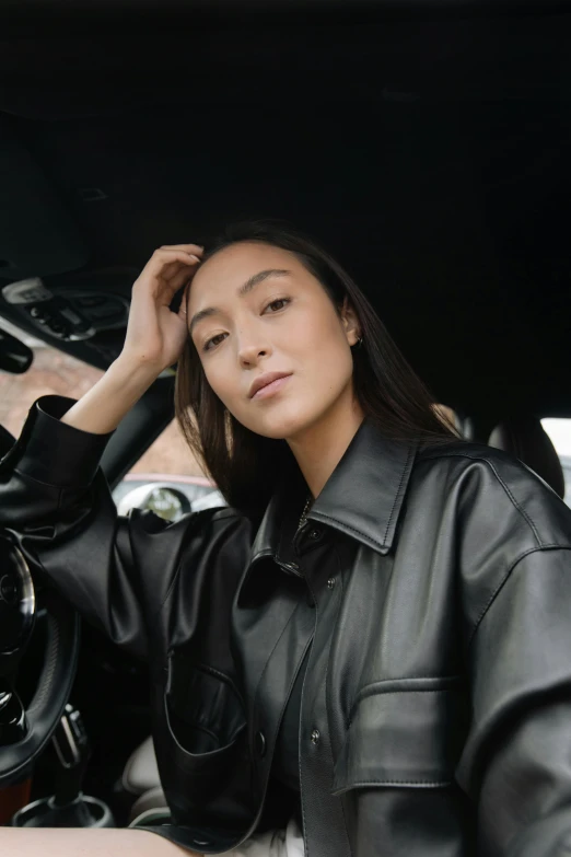 a woman sitting in the drivers seat of a car