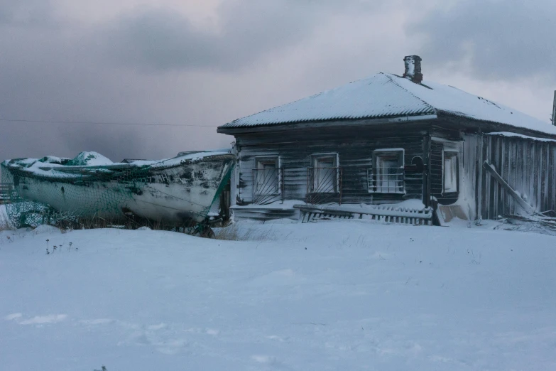 a boat is docked in the snow at the side of a building