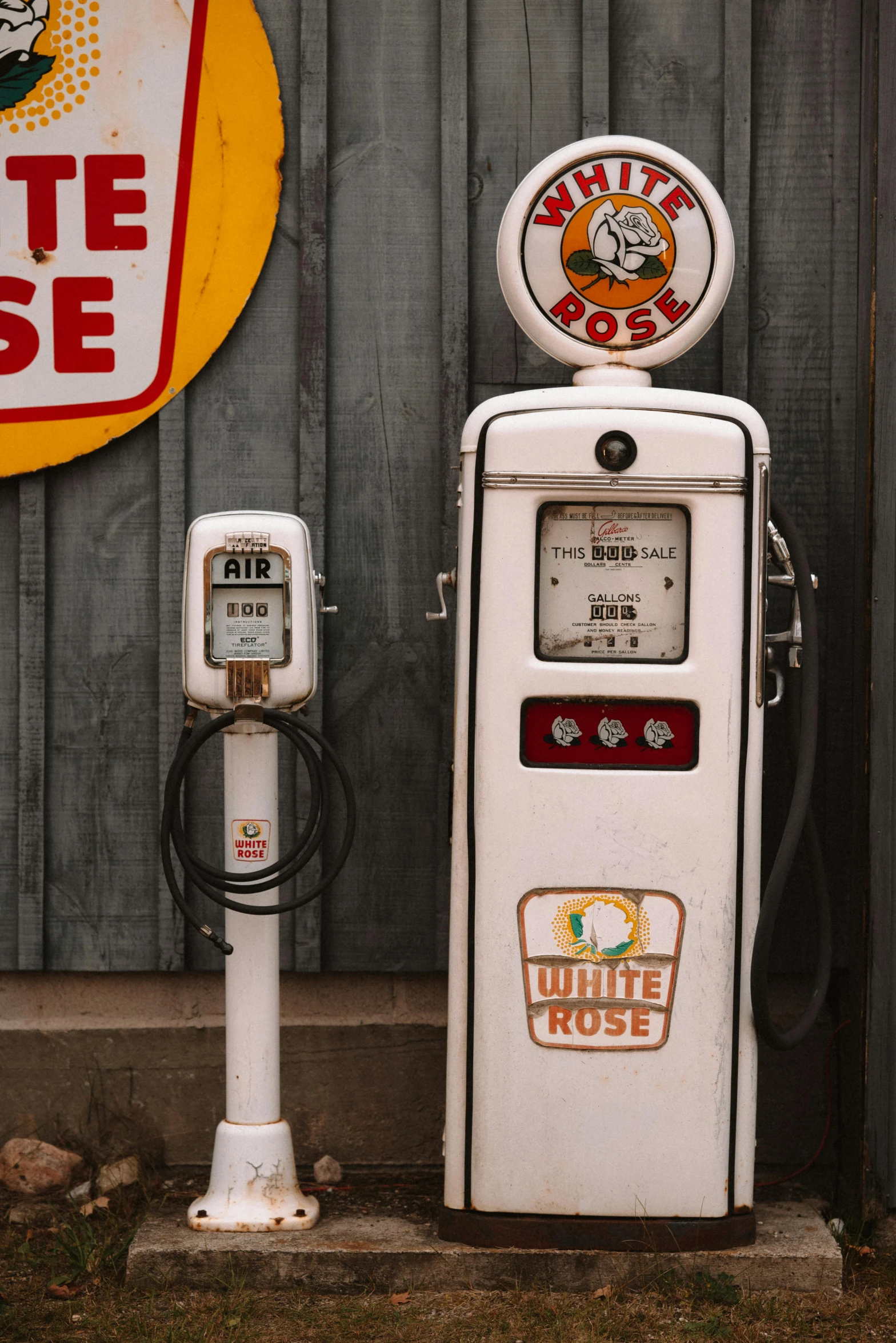 there is a white gas pump on the ground