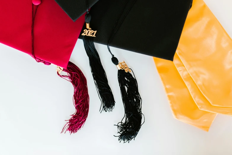 a graduation cap with black, yellow, and red