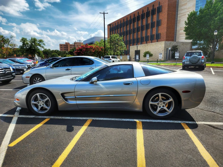 an older model car parked in a parking lot