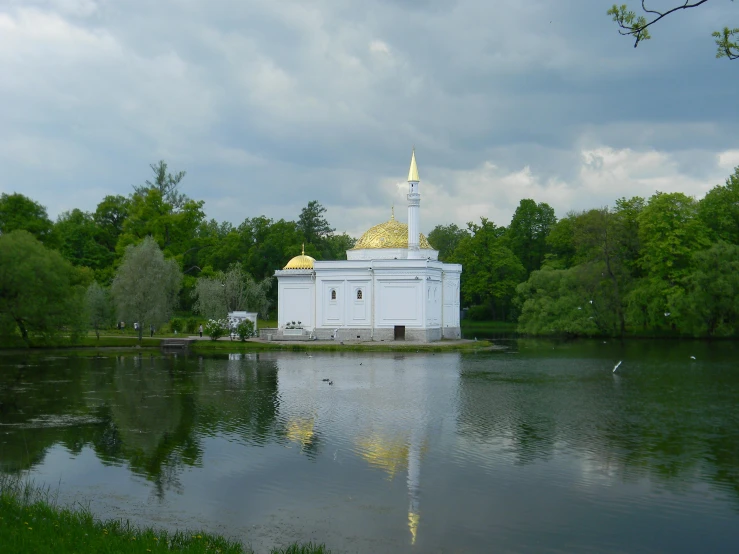 a lake that is filled with water and there is a building in the distance