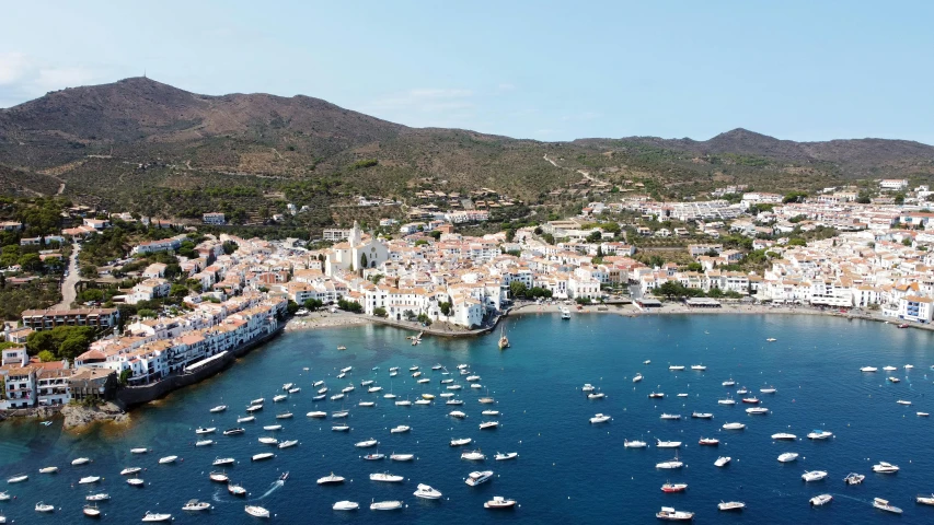 a town next to a harbor with lots of boats