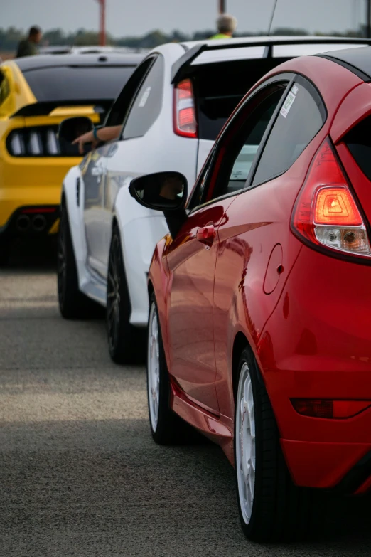 two sport cars are parked beside each other