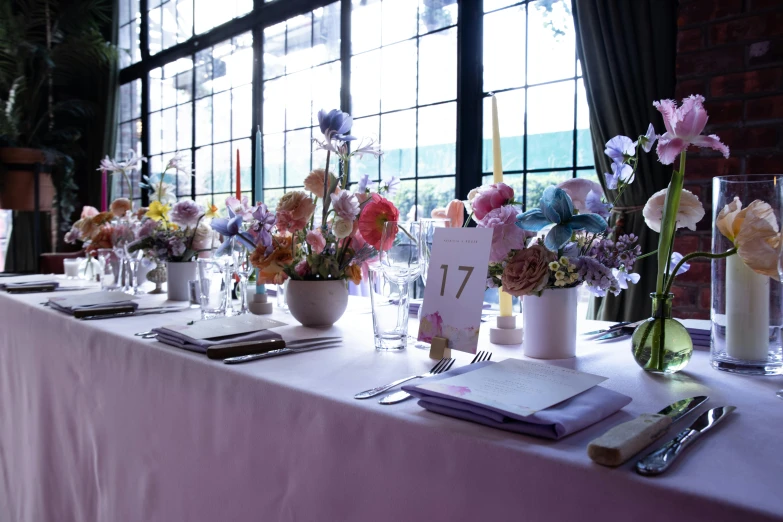 a long table is covered with many flowers