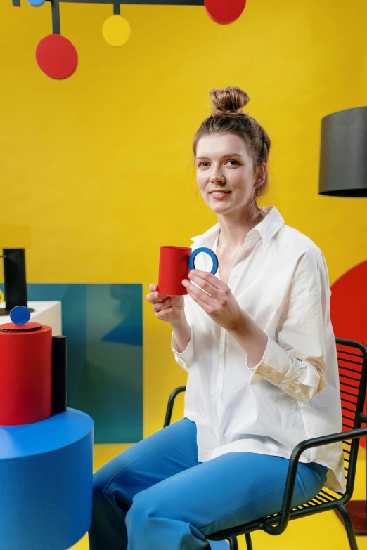 woman holding coffee cup with an object on top