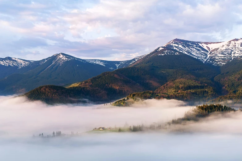 a view of the mountains covered in snow