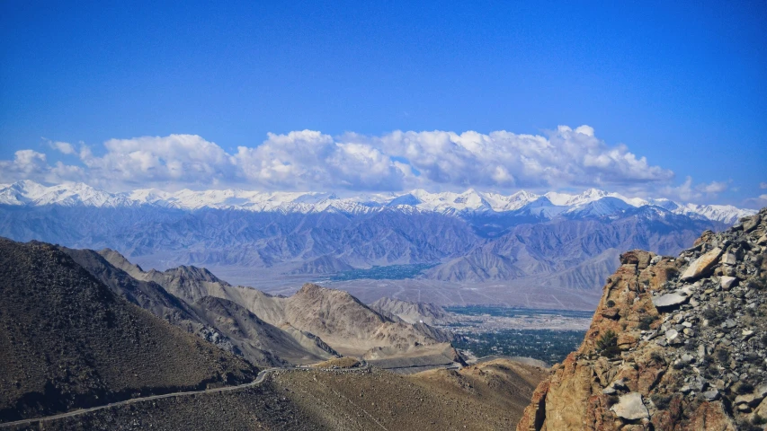 the mountains and snow covered peaks of a large plain