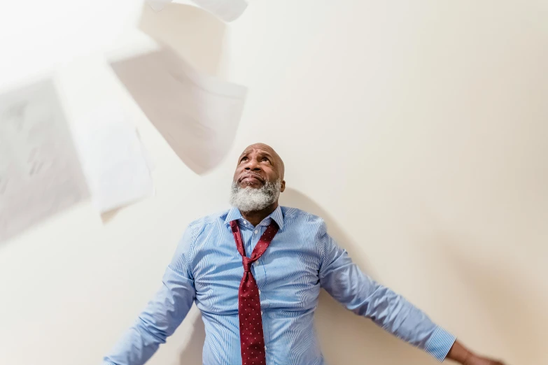 a man standing next to some sheets of paper