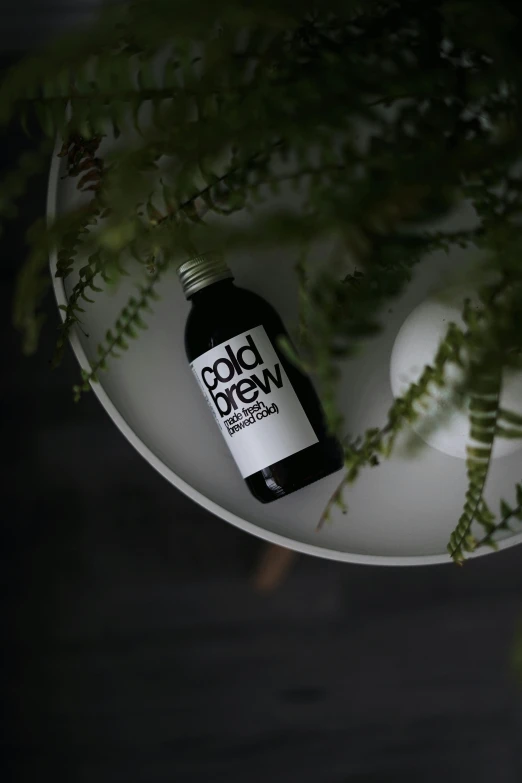 a small bottle of cbd hemicow sits on a plate