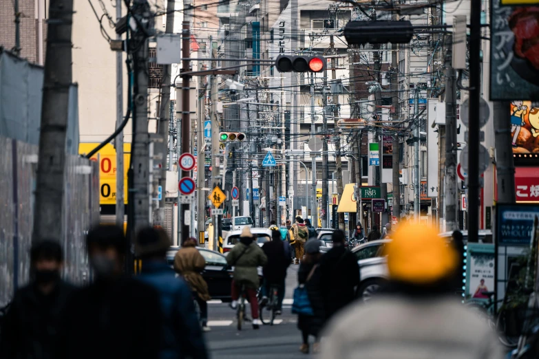 people are walking down a busy city street