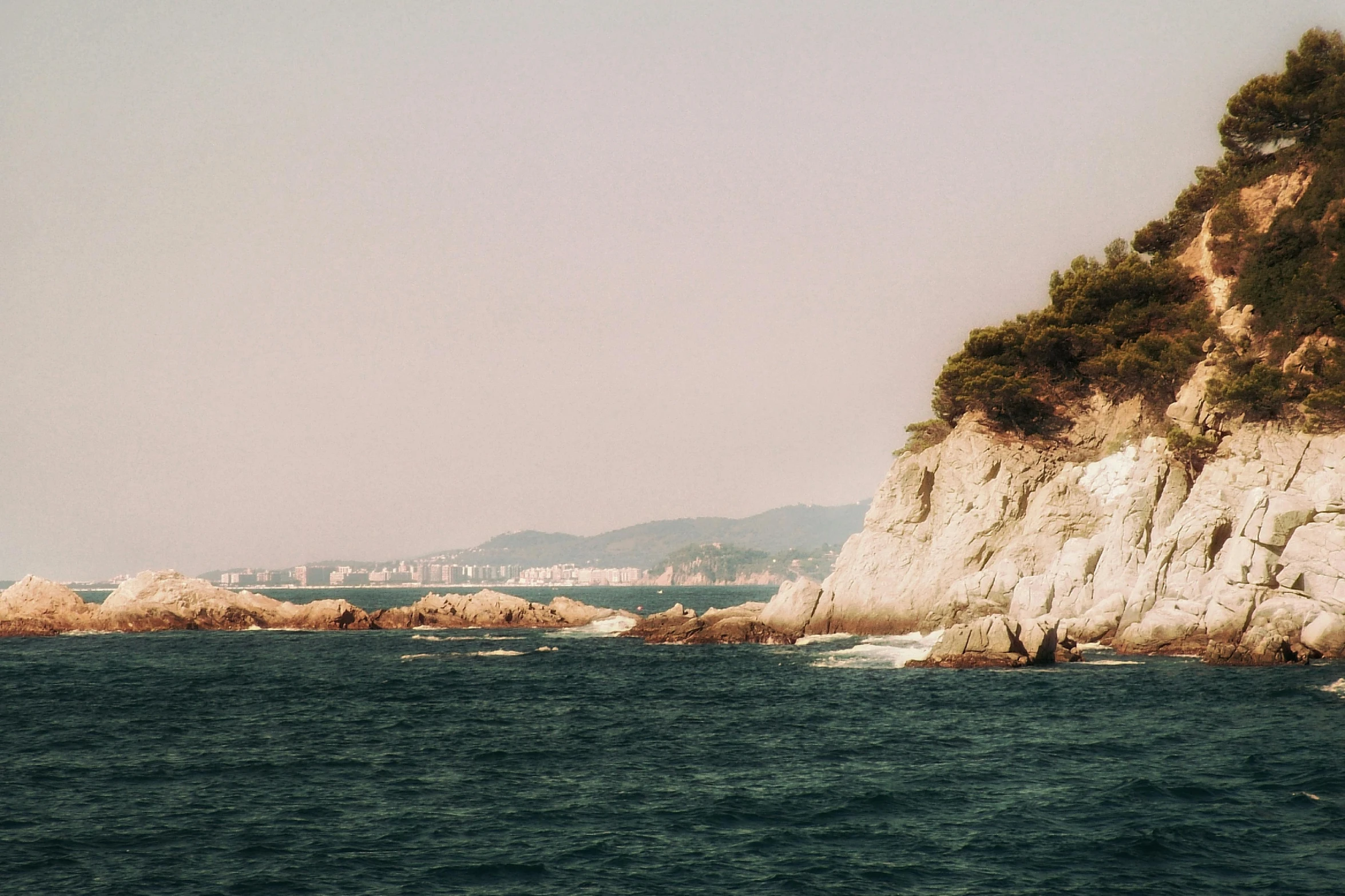 an image of a rocky outcropping from the ocean