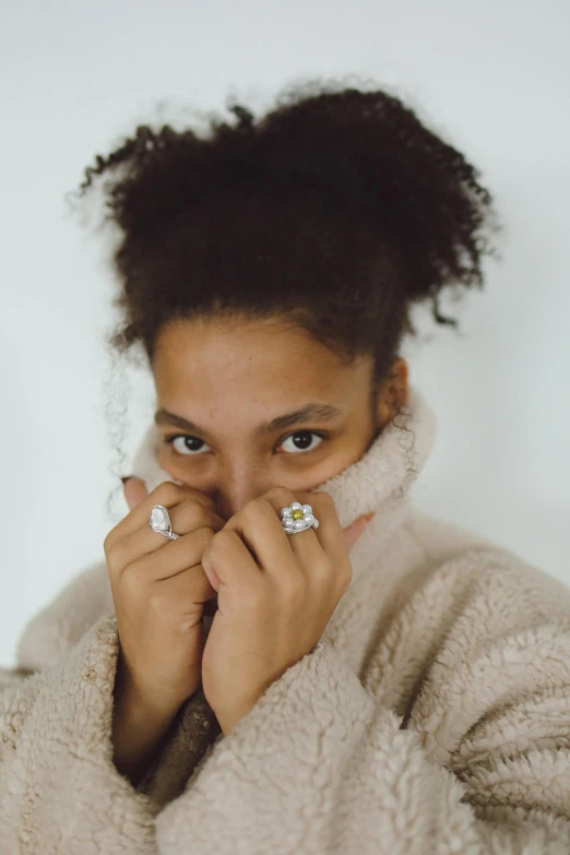 a woman with her fingers under her face