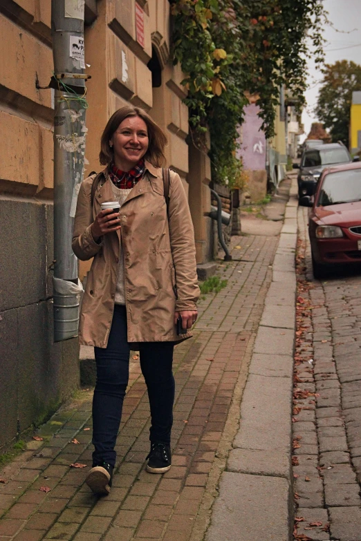 a girl with a smile, standing on the side walk