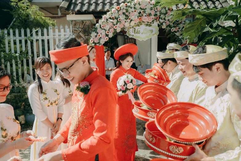 a group of young people in bright orange outfits