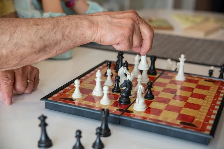 there is a man playing chess on the table