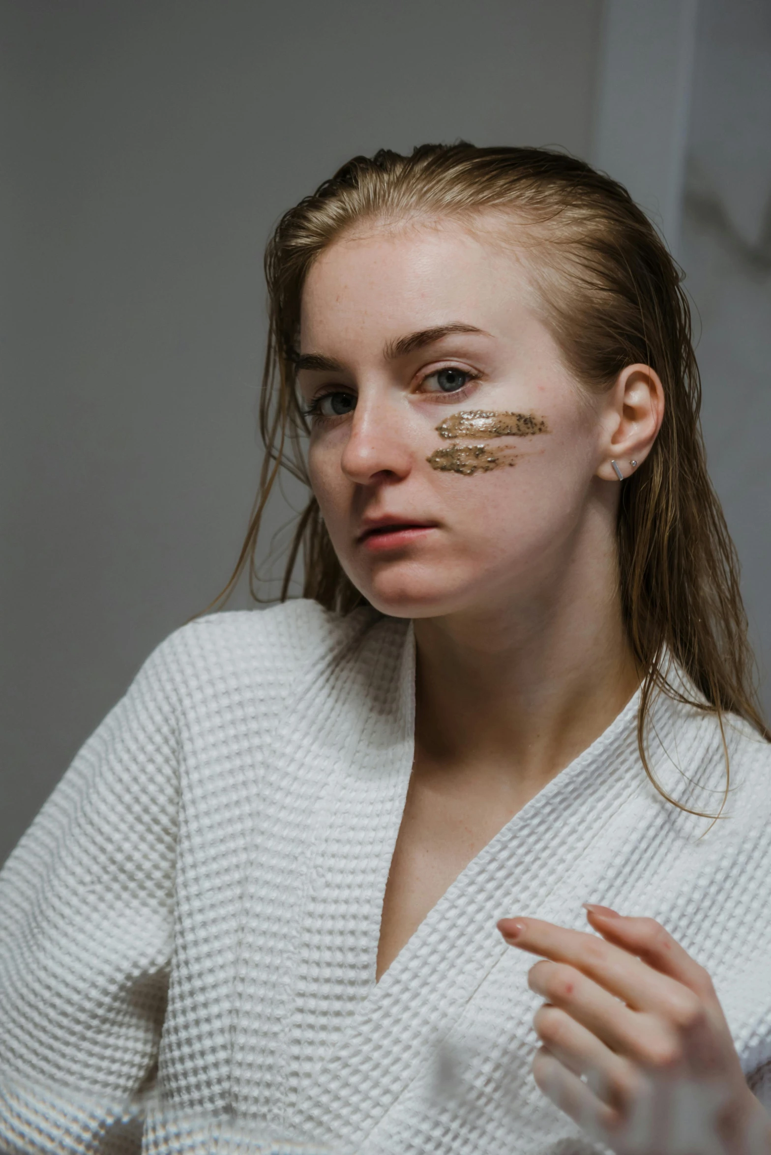 a woman has some gold tape on her face