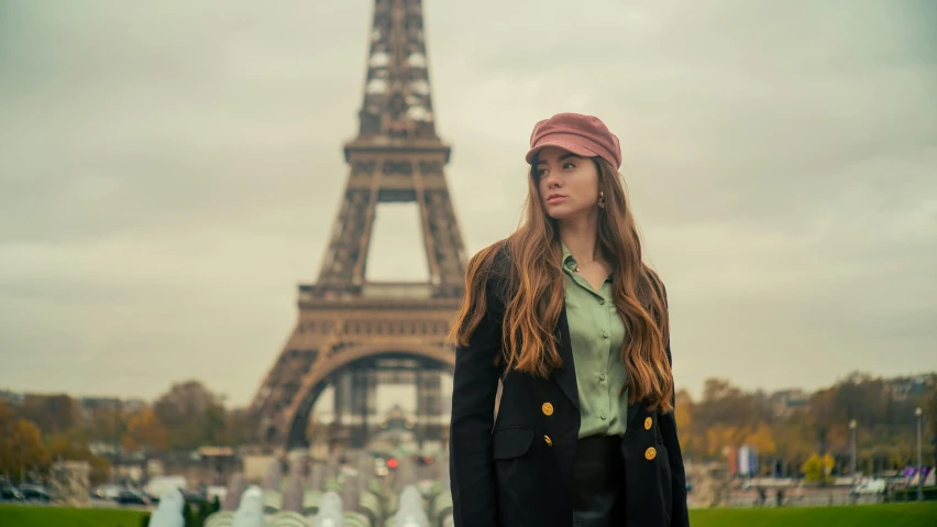 a woman is standing in front of a tower