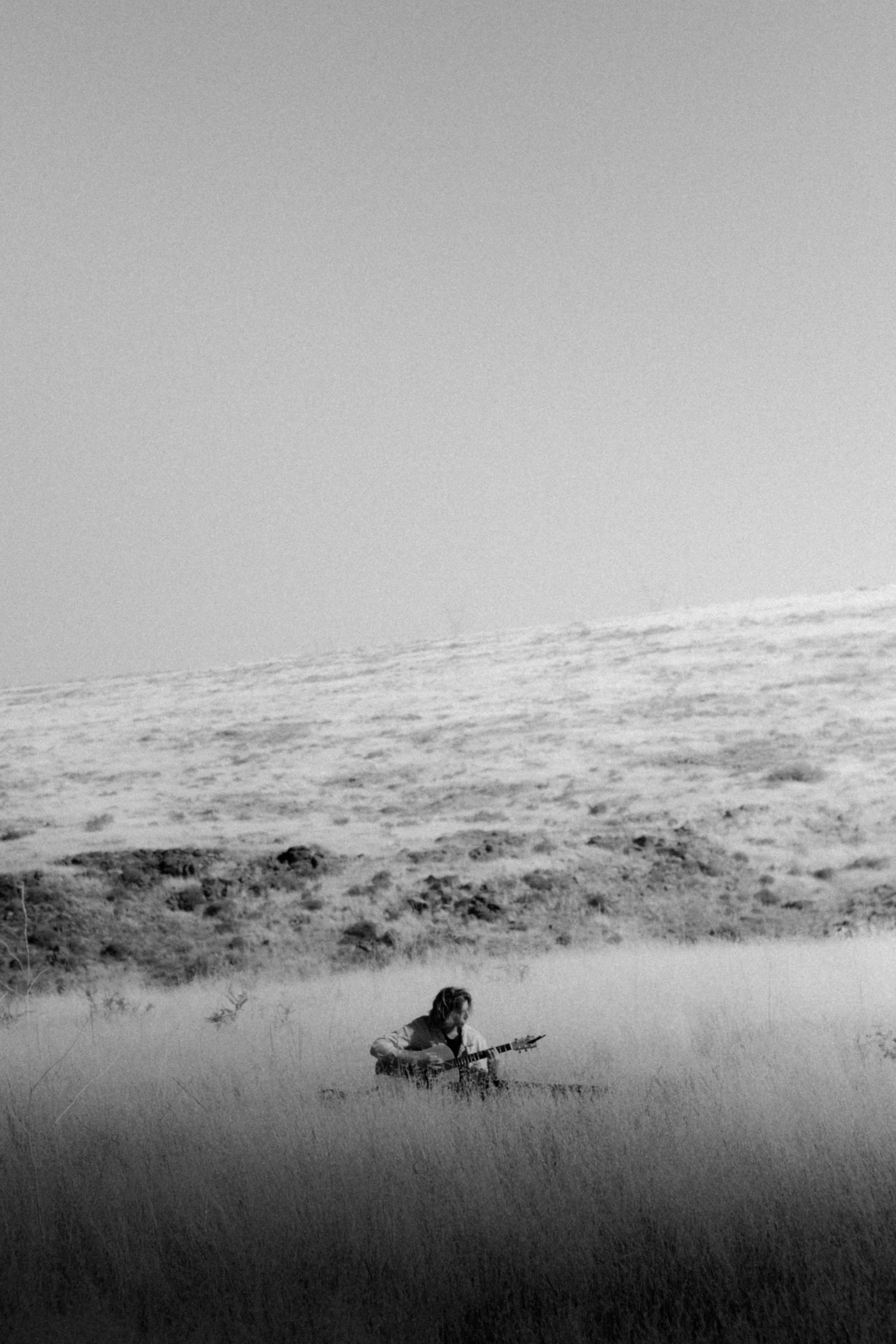 a person with skis standing next to an ocean