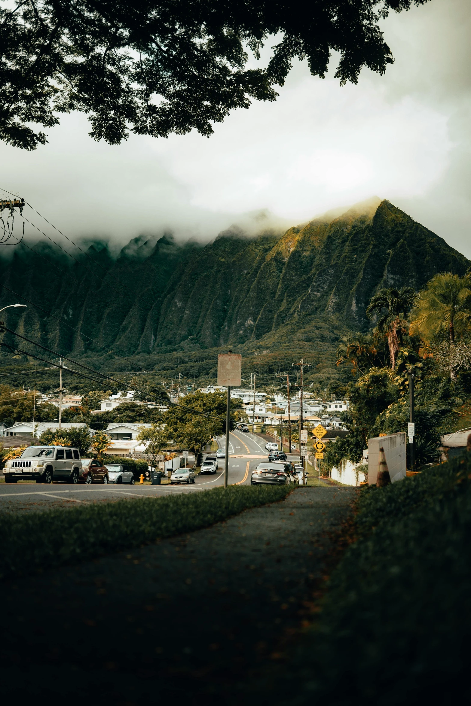 a long road with cars parked on the side