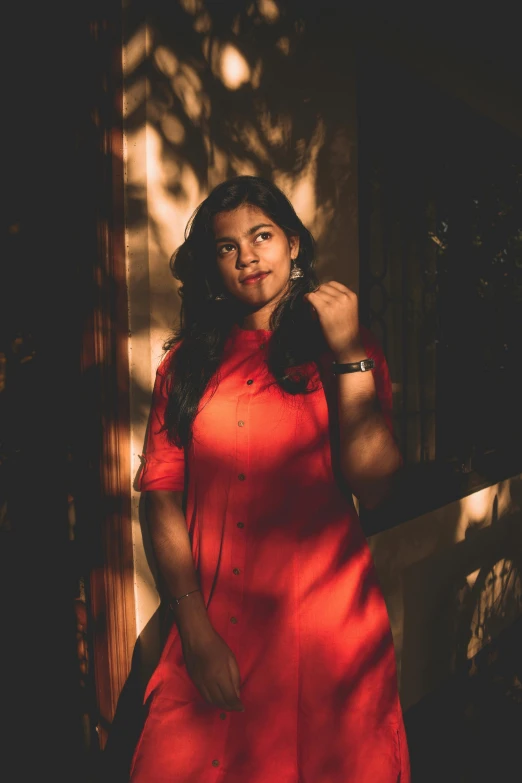 a woman in a red dress posing for a po