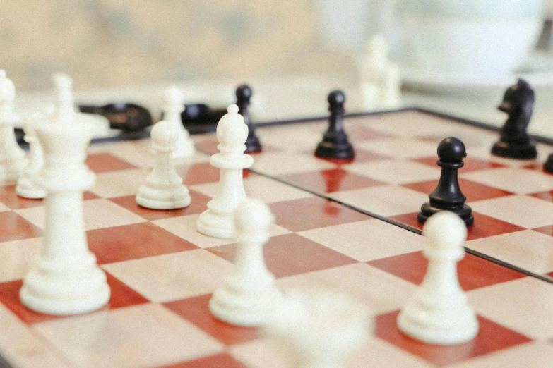 a chess board with a bunch of black and white pawns on it