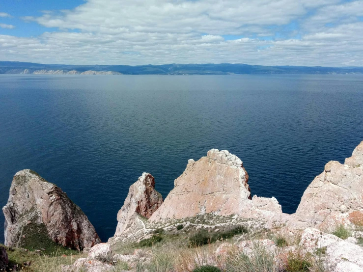 rocks are near the water that looks like they were floating in the ocean