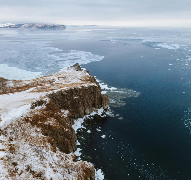 a cliff in the middle of a frozen lake