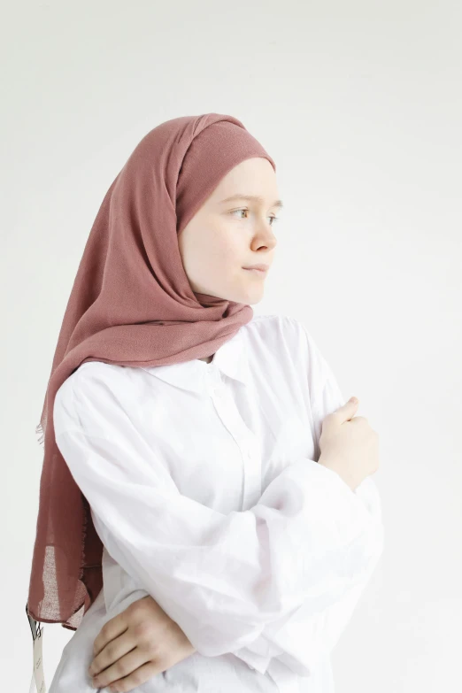 a woman in white shirt and pink head scarf