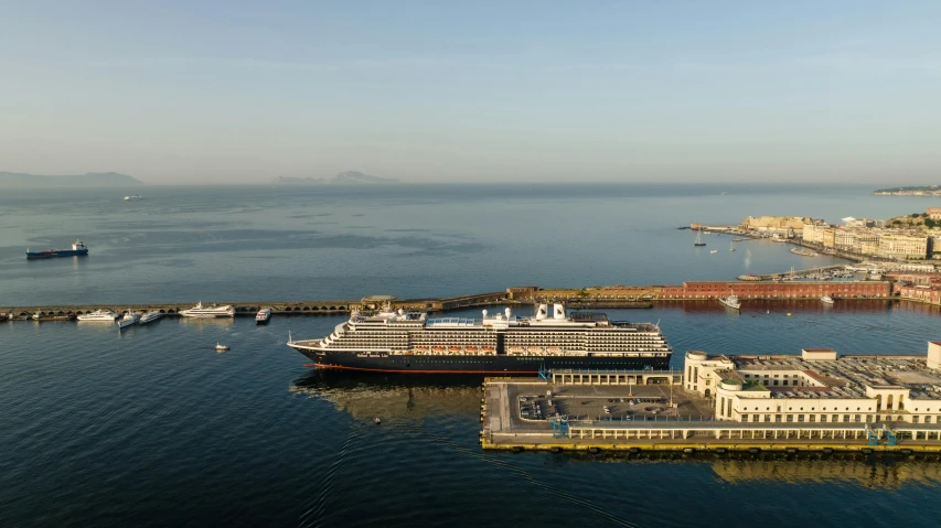 a large cruise ship docked at a pier in the ocean