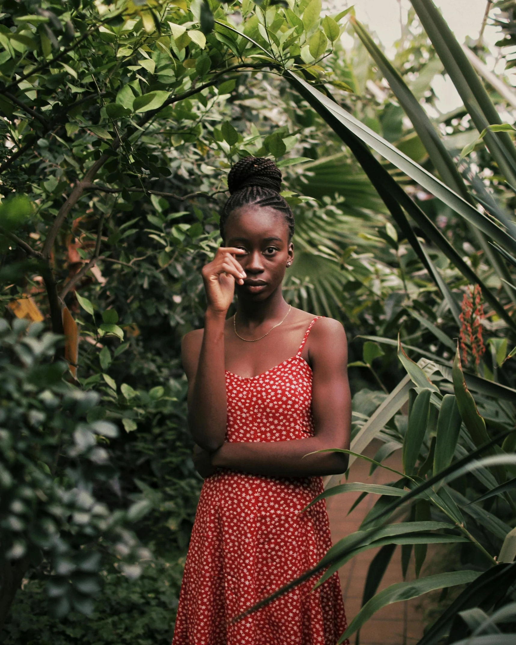 a woman standing outside in a bush talking on her cell phone