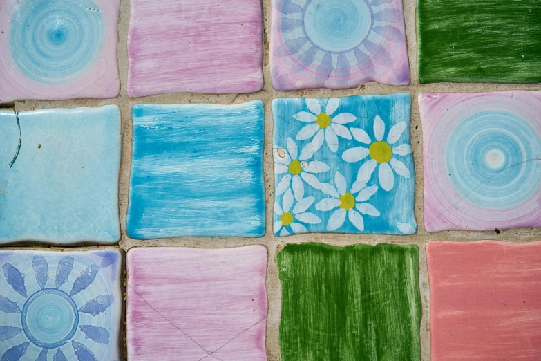 small squares of tile decorated with different colors