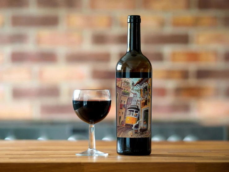 a glass and bottle sitting on a table